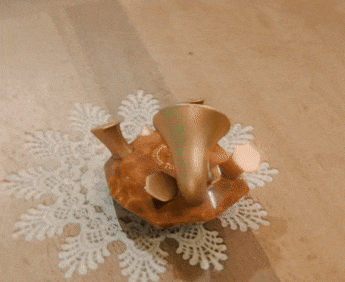 Gif of a 3D render of a gramophone turtle on its back, by the technician. The camera rotates around the render.